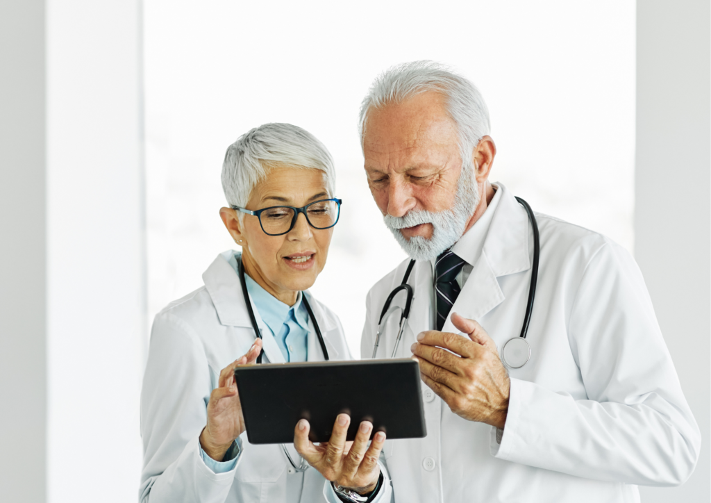 two older physicians reviewing patient chart